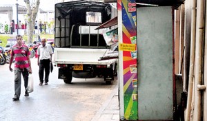 An accident waiting to happen: Pedestrians forced onto the middle of the road while business people take up the space