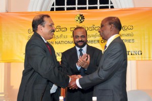 Picture shows the newly elected Chairman of the CNCI, Gamini Gunasekara  being greeted by outgoing Chairman  Preethi Jayawardena (left) in the presence of Secretary to the Ministry of Industry and Commerce, Anura Siriwardena.