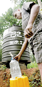 Villagers complain that the water supplied from these tanks do not even last a day. Pix by  Indika Handuwala