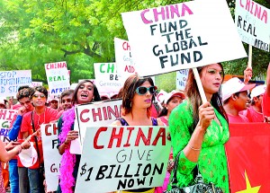 Indian activists participate in a protest organised by the nonprofit AIDS Healthcare Federation, which provides HIV patient care and support services, in New Delhi on October 25, 2013. The demonstrators demanded that China pledge some 1 billion USD for the global fund to fight AIDS, tuberculosis, and malaria, a figure they claim is commensurate with China's global economic standing. (AFP)