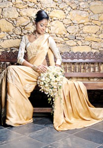 Ahinsa Lokudadella in a cream and gold Kandyan saree