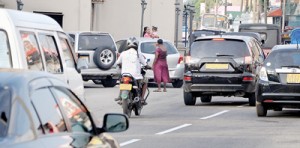 An unofficial 'traffic warden' directs a motorist to a parking spot near a  popular religious place of worship