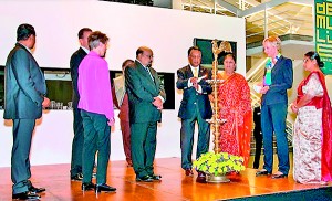 Sarath Konghage, Sri Lanka’s Ambassador in Germany  lighting the traditional oil lamp, while Hiran Houx, a representative of the Friends of the Museums, Raffael Gadebusch, Minister of National Heritage Dr. Jagath Balasuriya, Governor Kumari Balasuriya, Prof. Christina Haak and Secretary, Ministry of National Heritage Dr. Nanda Wickremesinghe look on.