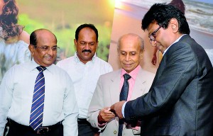 Picture shows Vipula Wanigasekera presenting copies of the book to Prof. Carlo Fonseka (second from right), Lanka Sportreizen Chairman Tilak Weerasinghe (who helped finance the publication) and Chandra Mohotti, veteran hotelier and chairman of the Sri Lanka Institute of Tourism and Hotel Management (left). Pic by Indika Handuwela