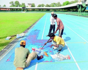 Hasty repairs being effected to the damaged track of Sugathadasa Stadium. 	           - Pic by Amila Gamage