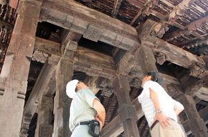 A close look: The Japanese team scrutinising Embekke’s famous carvings.  Pix by Nilan Maligaspe