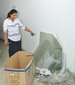 The contractor’s wife points to some of the damage caused. Pix by Susantha Liyanawatte