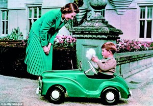 28th September 1952: Princess Elizabeth watching her son Prince  Charles playing in his toy car while at Balmoral