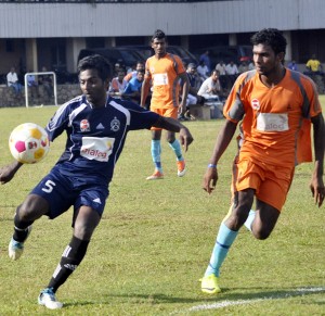 A Nandimithra (blue) player clears the ball. Pic by Susantha Liyanawatte