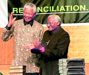 In 1995, Desmond Tutu leads the Truth and Reconciliation Commission (TRC) in gathering information and data on the human rights violations of the Apartheid era. In 1998, the TRC brands Apartheid as a crime against humanity South African President Nelson Mandela (L) with Archbishop Desmond Tutu, acknowledges applause after he received a five volumes of Truth and Reconciliation Commission final report from Archbishop Tutu, in Pretoria 29 October (AFP)