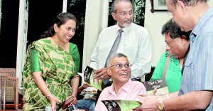 Author Dr. Sanjiva Wijesinha signs copies of the book at the launch