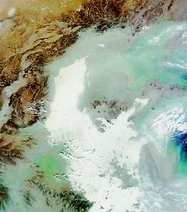 A satellite image shows smog stretching 750 miles from Beijing (top centre) to Shanghai (bottom right). Clouds are white and smog appears as grey swirls (NASA)