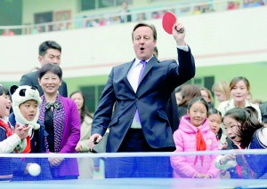 Batting away questions: Prime Minister David Cameron plays table tennis with primary school pupils during his trip to Chengdu, Sichuan province, but not all visitors have been so accommodating. A Chinese think tank has accused the British Museum of holding 'looted' artefacts (Reuters)