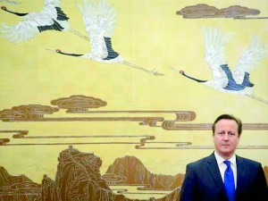 Britain's Prime Minister David Cameron stands before a painting before a signing ceremony at the Great Hall of the People in Beijing December 2 (Reuters)