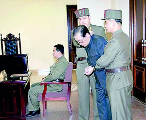 Jang Song Thaek, the uncle of leader Kim Jong Un, with his hands tied with a rope, is dragged into the court by uniformed personnel December 12  (REUTERS/Yonhap)
