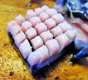 Greenland has some unusual Christmas recipes; tucking into Mattak (raw whale skin, served with blubber) (© CC BY-SA 2.0 'The coders way of cutting mattak'by  Risager)