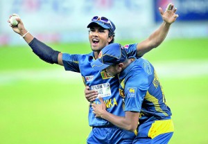 Sri Lanka's Dinesh Chandimal celebrates after taking a catch to dismiss Pakistan's Sohaib Maqsood during their second Twenty20 international cricket match in Dubai