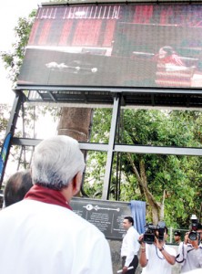 Speaker Chamal Rajapaksa looks up at the giant screen at Parliament grounds on October 23, the first day on which House proceedings were telecast live