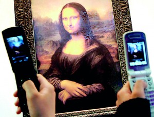 A crowd gathers around Leonardo Da Vinci's Mona Lisa at the Louvre (AFP)