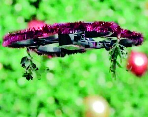 Creepy or lovely? Two San Francisco artists have taken to the city's bustling Union Square with a drone festooned with tinsel and mistletoe (Youtube)