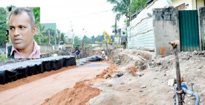 Athula Dias (inset): His parapet wall (above) was taken down and some five perches of his land taken without any official valuation of the property