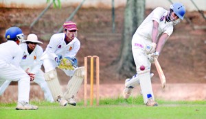 Dharmapala batsman Harsha Gallage, who hit an unbeaten 82, is about to launch a shot  against Ananda at Ananda Mawatha. - Pic by Amila Gamage