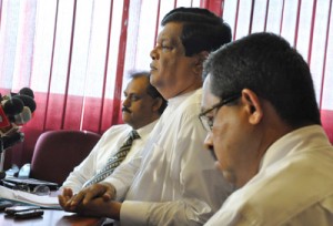 Education Minister Bandula Gunewardene, at the centre of a controversy over remarks he made about the Year Five Scholarship Exam explains his position at a news conference last week. Examination Commissioner W.M.N.J. Pushpakumara (left) is also in the picture. Pic by Susantha Liyanawatta