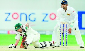 Pakistan batsman Sarfraz Ahmed  lunges forward to defend the ball off Rangana Herath as wicketkeeper Prasanna Jayawardene looks during the fourth day of the second cricket Test in Dubai  yesterday. AFP PHOTO/Ishara S. KODIKARA