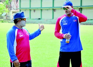 Nepal coach Pubudu Dasanayake discusses a point with his skipper Paras Kadhka