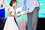 Commercial Bank’s  e-Exchange presents  exercise books to a 1000 children