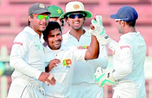 Rangana Herath celebrates the dismissal of Pakistani batsman Ahmed Shehzad-AFP