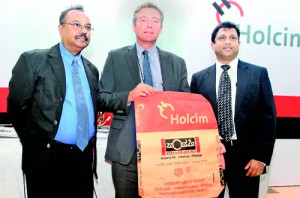 From left - Asela Iddawela, Vice President – Sustainable development and external affairs, Holcim; Philippe Richart, CEO, Holcim; and Nalin Karunaratne, Vice President – Marketing and Sales, Holcim with the packaging.