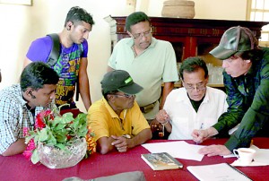 Director Chandran Rutnam and son James (far right) discussing the nitty-gritty with the crew