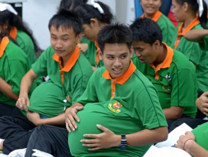 Students putting balloons under their shirts to look pregnant during a sex education programme in Bangkok. AFP
