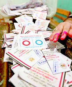 Officials count ballots after polls closed during the final stage of a referendum on Egypt's new constitution in Cairo, January 15 (REUTERS)