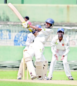 SSC batsman Vishwa Wijeratne, who made an unbeaten 116, slams one to the fence vs Chilaw Marians at the SSC. - Pic by Ranjith Perera