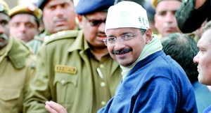New Delhi Chief Minister Arvind Kejriwal smiles as he sits during a protest in the streets of New Delhi on January 20, 2014. (AFP)