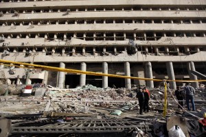 Police officers inspect the site of a bomb attack in front of the damaged Cairo Security Directorate building, which includes police and state security, in downtown Cairo (REUTERS)