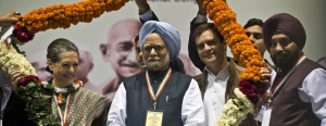 Congress Party President Sonia Gandhi, Indian Prime Minister Manmohan Singh and Congress Vice President Rahul Gandhi pose inside a garland during a party meeting in New Delhi. AFP