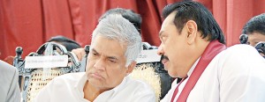 President Rajapaksa though being far apart from Opposition Leader Ranil Wickremesinghe on vital policies, whispers into his ear at a ceremony on Friday to mark the opening of the Sama Vihara at Havelock Town.  Pic by Santha Ratnayake