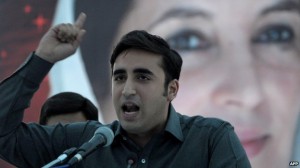 Bilawal Bhutto Zardari lashes out at the government in front of a poster of his late mother, in 2013 (AFP)