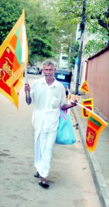 Come buy my flags:  A man selling National  Flags on the streets of Colombo yesterday.  Pic by Nilan Maligaspe