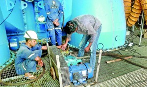 Men at work: Indians and locals yesterday attend to repairs at the Norochcholai  power plant