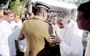 An officer and a policeman: A careful word of advice from former Army Commander Sarath Fonseka to an official who had attempted to disrupt his propaganda meeting in the Southern town of Balapitiya recently. Pic by Hemantha de Silva
