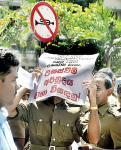 Unfortunate: A noisy protest takes place near a sign asking for silence. Pic by Indika Handuwala