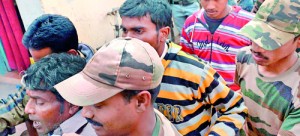 Police (foreground) lead gang-rape suspects to a district courthouse in Bolpur of Birdhum district, some 240 kilometres (149 miles) north west of Kolkata, on January 24, 2014. A total of 13 men have been arrested over the assault on a 20-year-old in the village of Subalpur, which was allegedly as punishment for "dishonouring" her community.  AFP PHOTO/Dibyangshu SARKAR