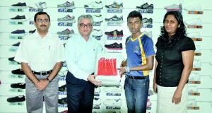 Shamsul Muneer (pictured second from right) received his prize from Vikas Anand (second from left), the Company Manager of Bata Sri Lanka at the Bata showroom situated at Dahamco Building in Ratmalana.  Also in the picture are Ayan Bhattacharyan (left), the Retail Manager and Gayani Rajapaksha (right), the Costing and Efficiency Manager for Bata Sri Lanka.  			         - Pic by Ranjith Perera