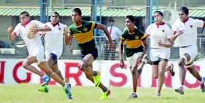 A Royal Panadura player chases down a fleet-footed Trinitian - Pic by Amila Gamage