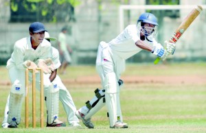 St. Peter’s batsman Didulan Mendis drives watched by Royal wicketkeeper Thiran Dhanapala at Reid Avenue - Pix by Ranjith Perera