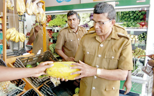 A raid being carried out at a super market in Beruwala. Pic by S. Siriwardhena